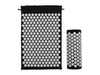 Black acupressure mat and a rolled-up acupressure pillow