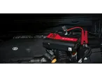 A portable Ultimate Speed jump starter connected to a car battery.