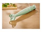 SilverCrest immersion blender on a wooden surface with basil and cheese.