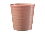 A pale pink ceramic tumbler with subtle horizontal lines.