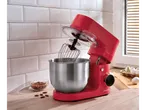 A red SILVERCREST® Stand Mixer with a whisk attachment and a bowl of almonds.