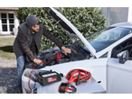 Man using ULTIMATE SPEED® Car Battery Charger to jump-start a car.