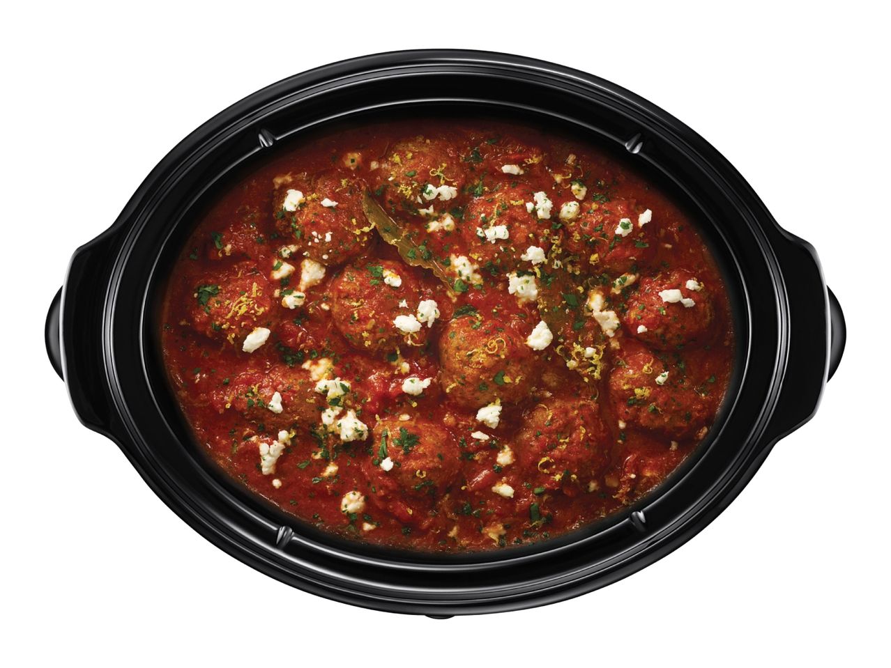 Meatballs in tomato sauce with feta cheese and herbs in a slow cooker
