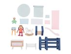 A collection of dollhouse furniture and accessories, including dolls, a rocking horse, and beds.