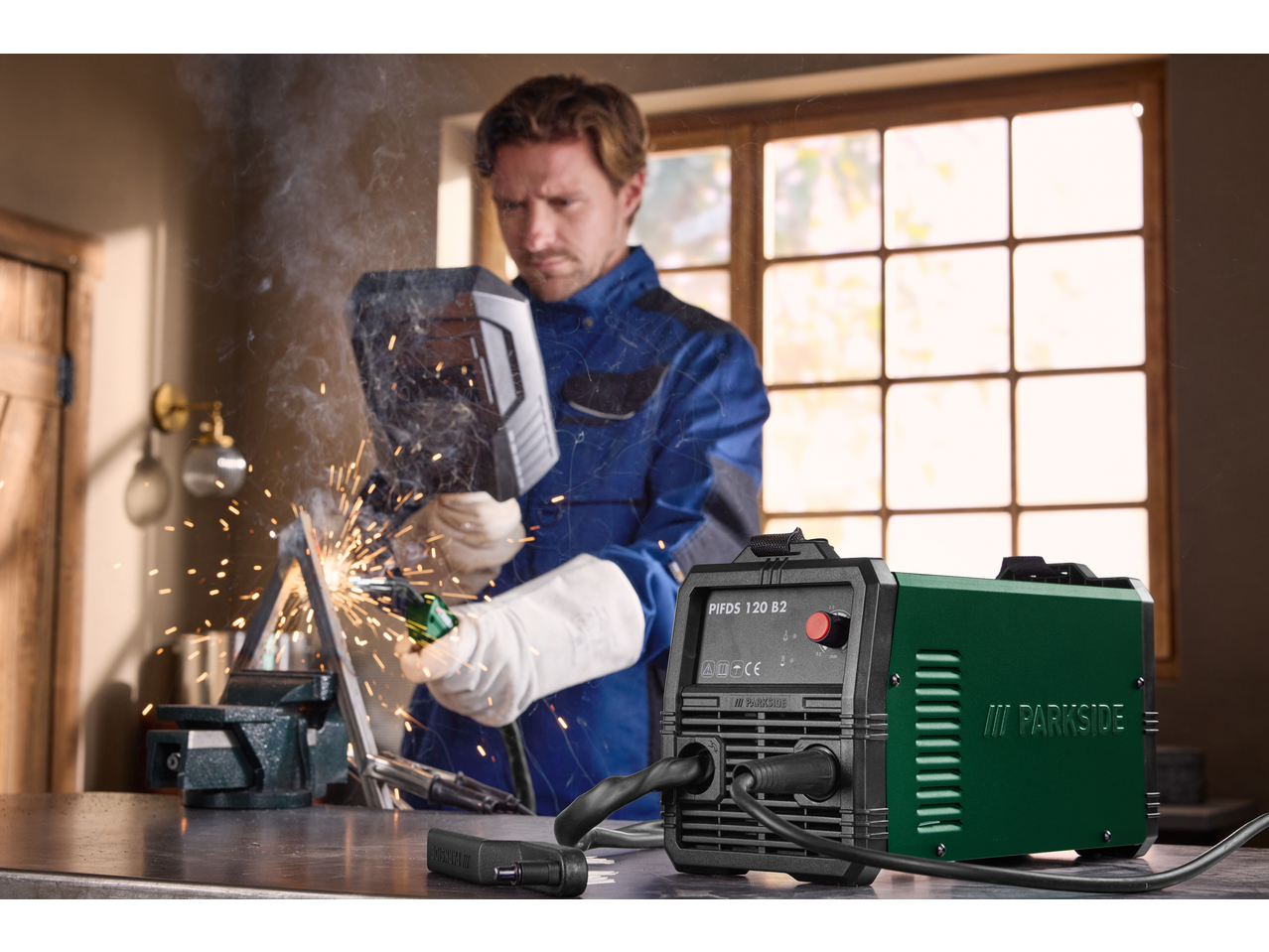 PARKSIDE® Inverter Flux Cored Wire Welder in use, welding metal with sparks and smoke.