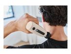 Person massaging their neck with a handheld massager.