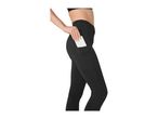 Woman in black leggings with a phone in the side pocket.