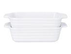 Two white rectangular ceramic baking dishes with handles, stacked on top of each other.
