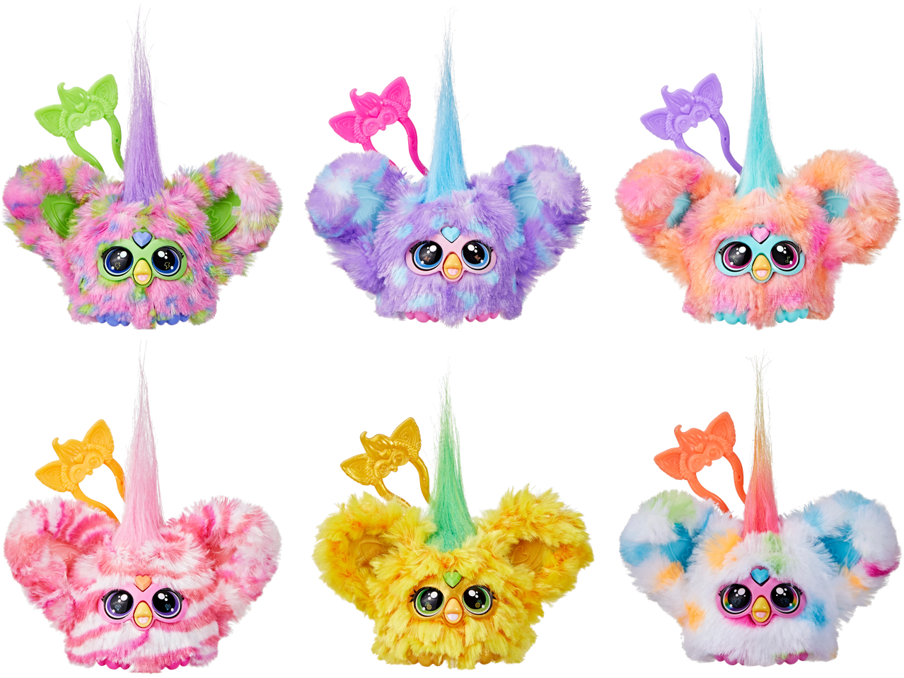 Sešas plīša Furby Furblets rotaļlietas dažādās krāsās, ar ragiem un galvas lentēm.