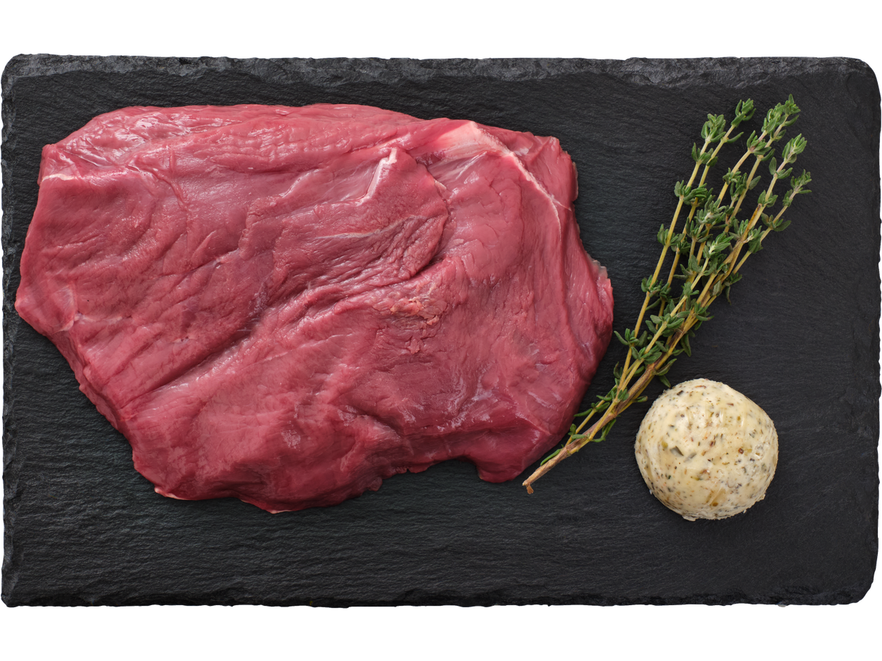 Toores veiselihasteik tüümiani ja ürdivõiga tumedal kiltkiviplaadil.