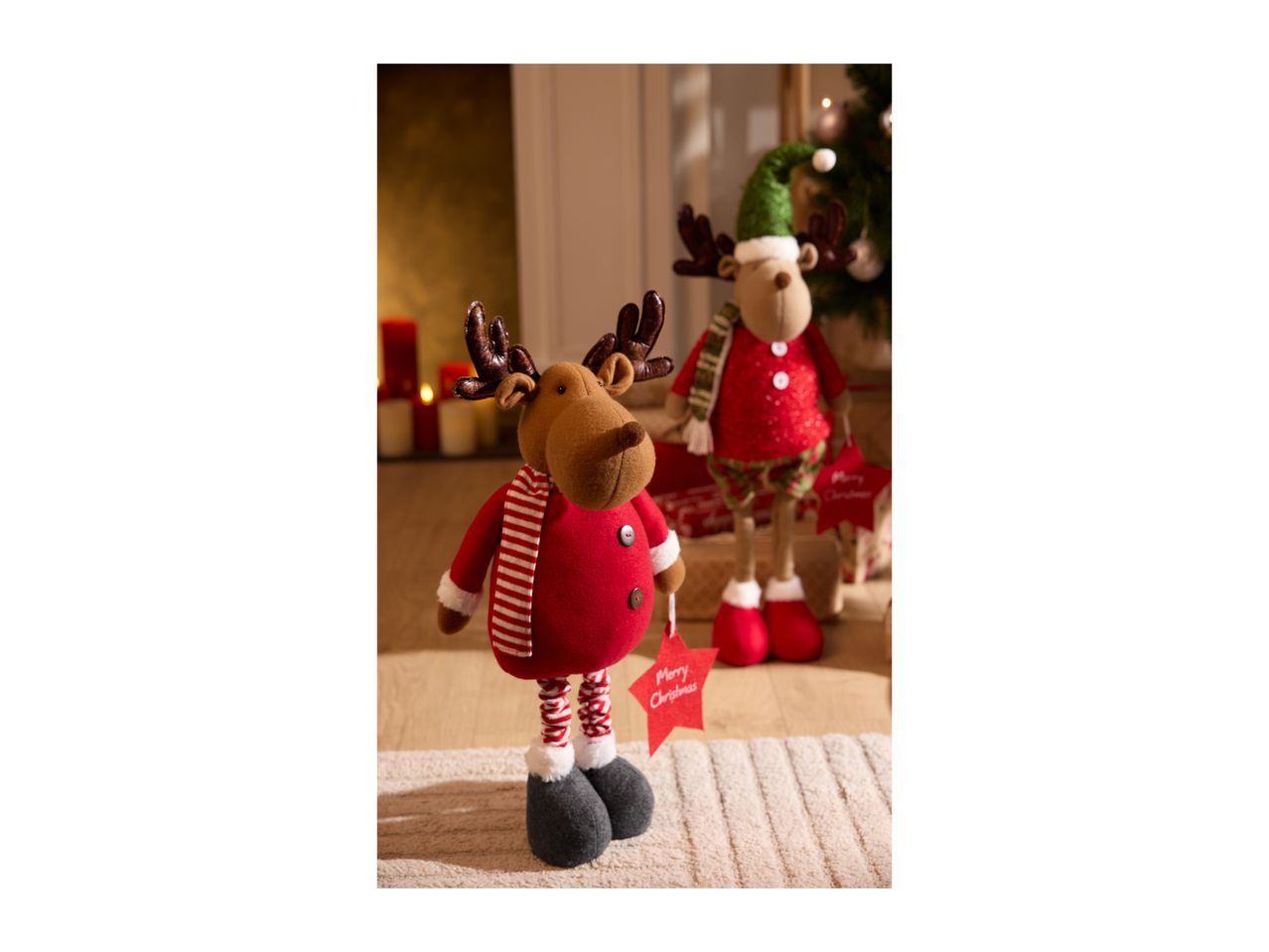 Two festive reindeer plush toys, one in red with a striped scarf, the other in green.