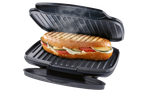 A delicious panini is cooked to perfection in a black panini press.