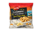 Indpakkede blæksprutteringe i dej med citron og dip, klar til stegning.