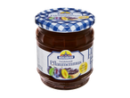 Mühlhäuser pruimenjam in een pot met geruit deksel en een afbeelding van pruimen en brood.
