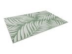 Green and white outdoor rug with a palm leaf pattern