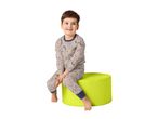 Smiling boy in dinosaur pajamas sitting on a green pouffe.