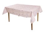 Pink tablecloth with a delicate floral pattern draped over a wooden table.