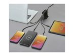 A multi-port charger connected to a laptop, tablet, and three smartphones, all charging.