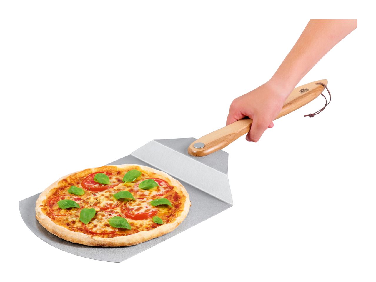 A hand holding a pizza peel with a freshly baked pizza topped with tomatoes and basil.