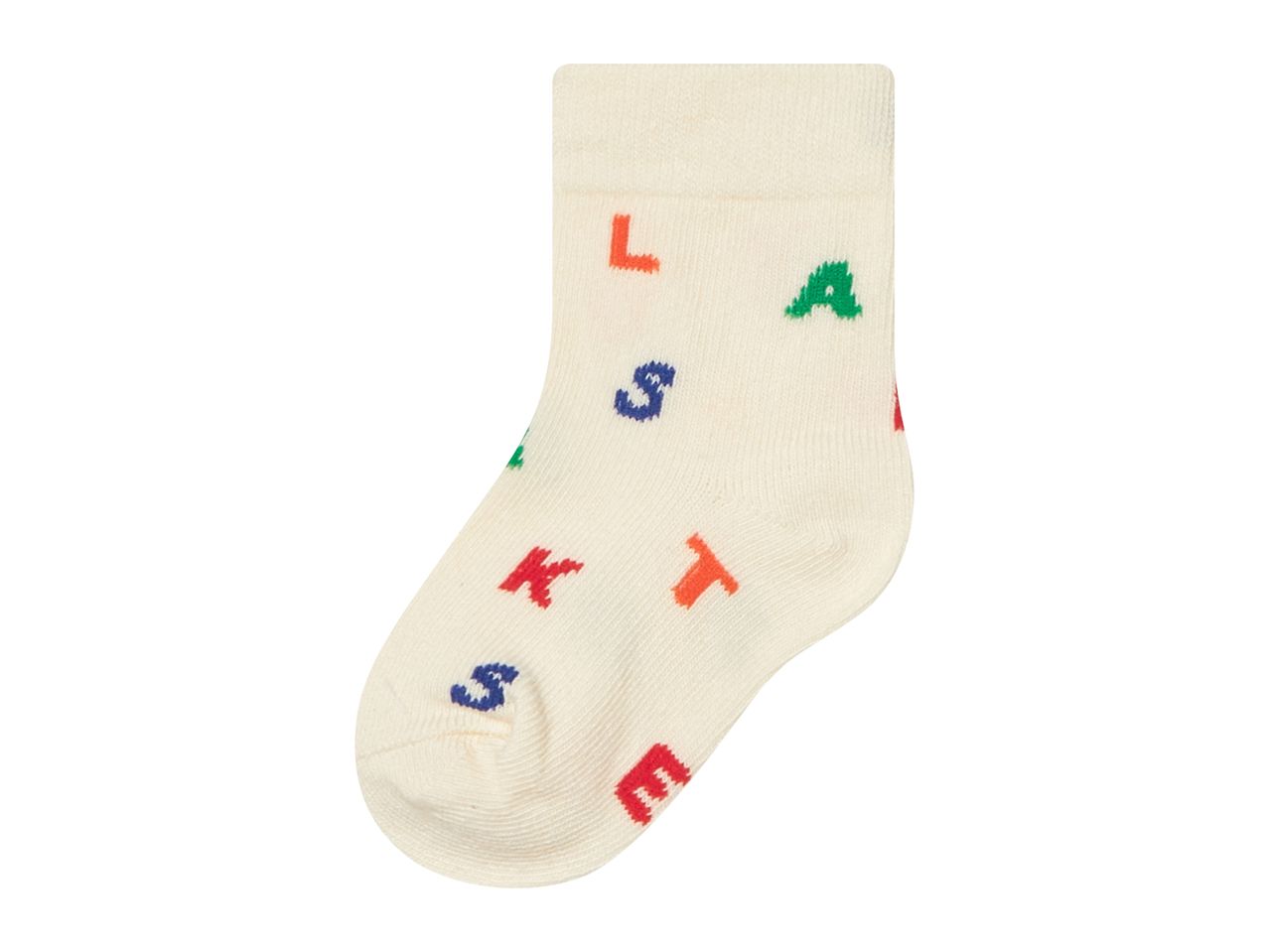 A single cream-colored sock with colorful letters 