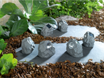 Six solar-powered rock lights illuminate a garden path.
