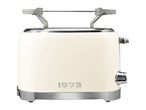 Cream-colored retro toaster with a bun warmer attachment and the year 1973 on the front