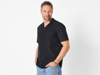 Man wearing a black Esmara Men's Seersucker Casual Shirt and light blue jeans.
