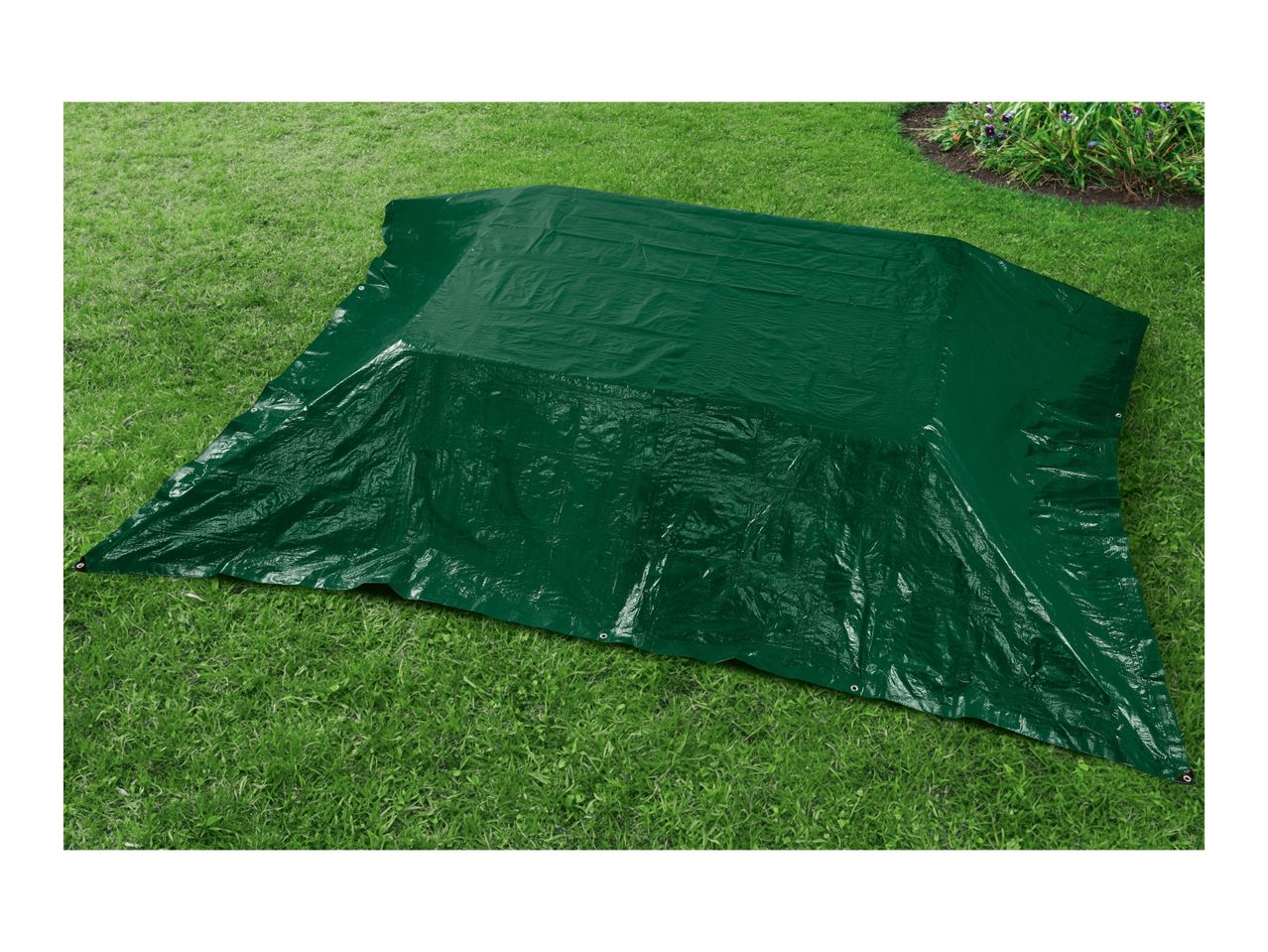 A dark green tarp covers a rectangular area on a grassy lawn.