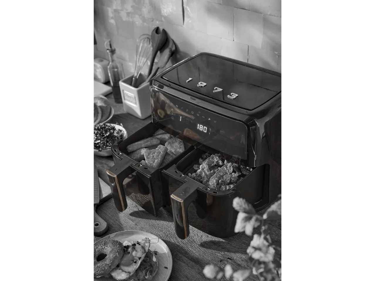 SILVERCREST® Dual Basket Air Fryer with food inside, on a kitchen counter.