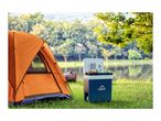 Camping tent and portable cooler with drinks and fruit by a lake.