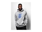 Man in a grey hoodie with an England football crest, hands in pockets.