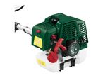 Close-up of a petrol grass trimmer engine with starting instructions and specifications.
