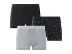 Three pairs of men's boxer briefs: one black, one gray, and one black with green cactus print.