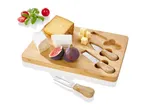 Bamboo cheese board with three cheese knives and assorted cheeses and figs.