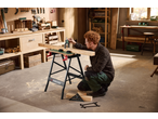 Man using a Parkside® digital depth gauge on wood, with a Parkside® workbench and measuring tools.