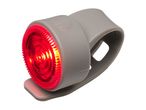 Grey silicone bicycle rear light with a bright red LED, featuring a power button.