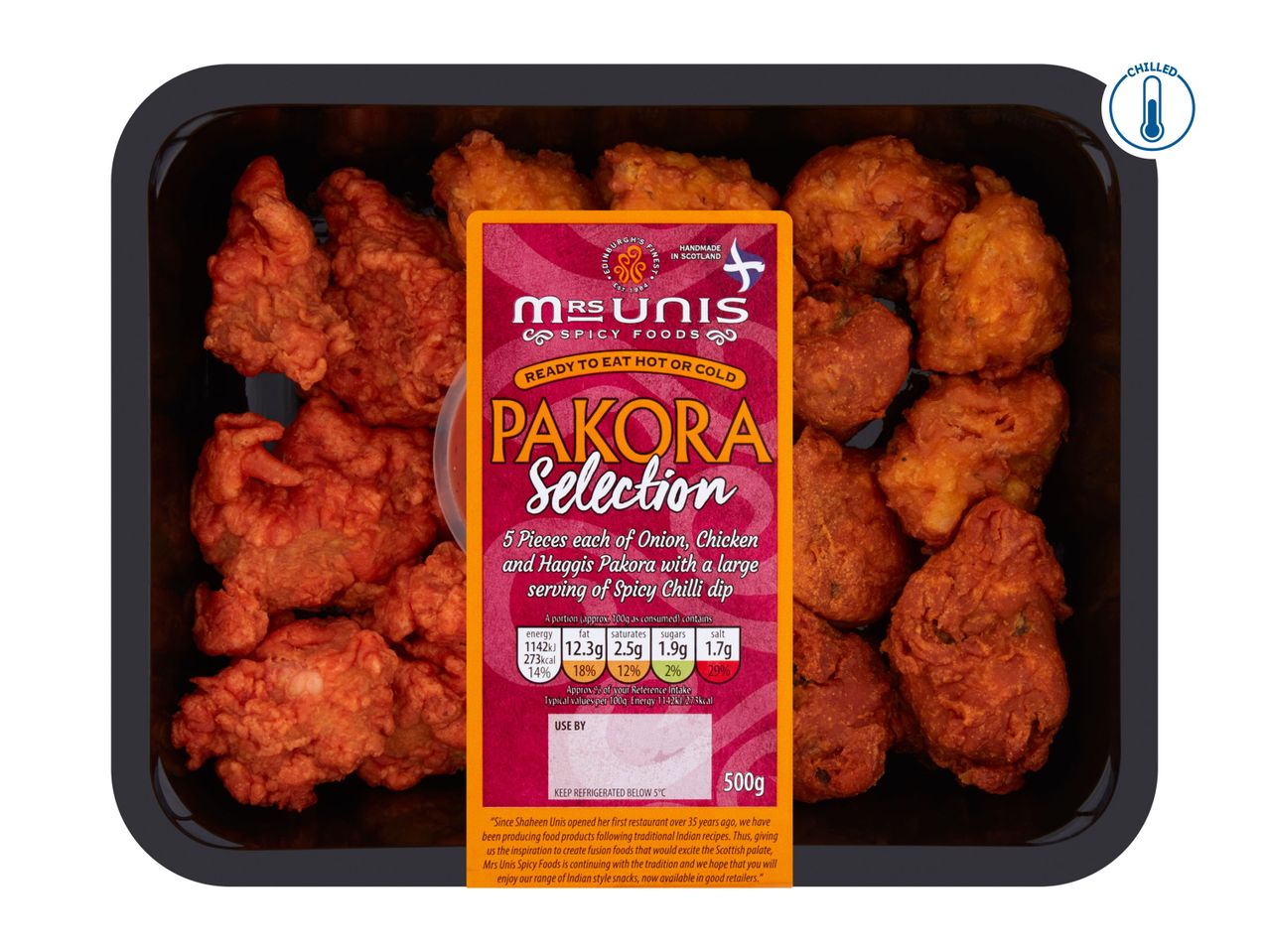 A black tray of Mrs Unis Pakora Selection, including onion, chicken, and haggis pakora with a chili dip.