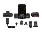 A Ryobi cordless vacuum cleaner and its accessories, including charging station and various attachments.