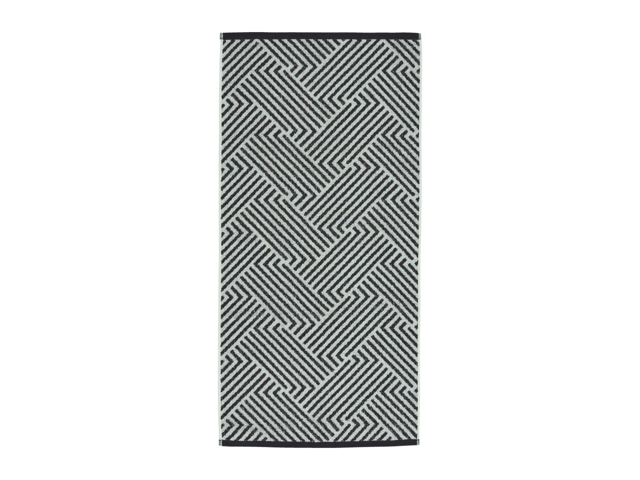 Black and white geometric pattern runner rug with a maze-like design.