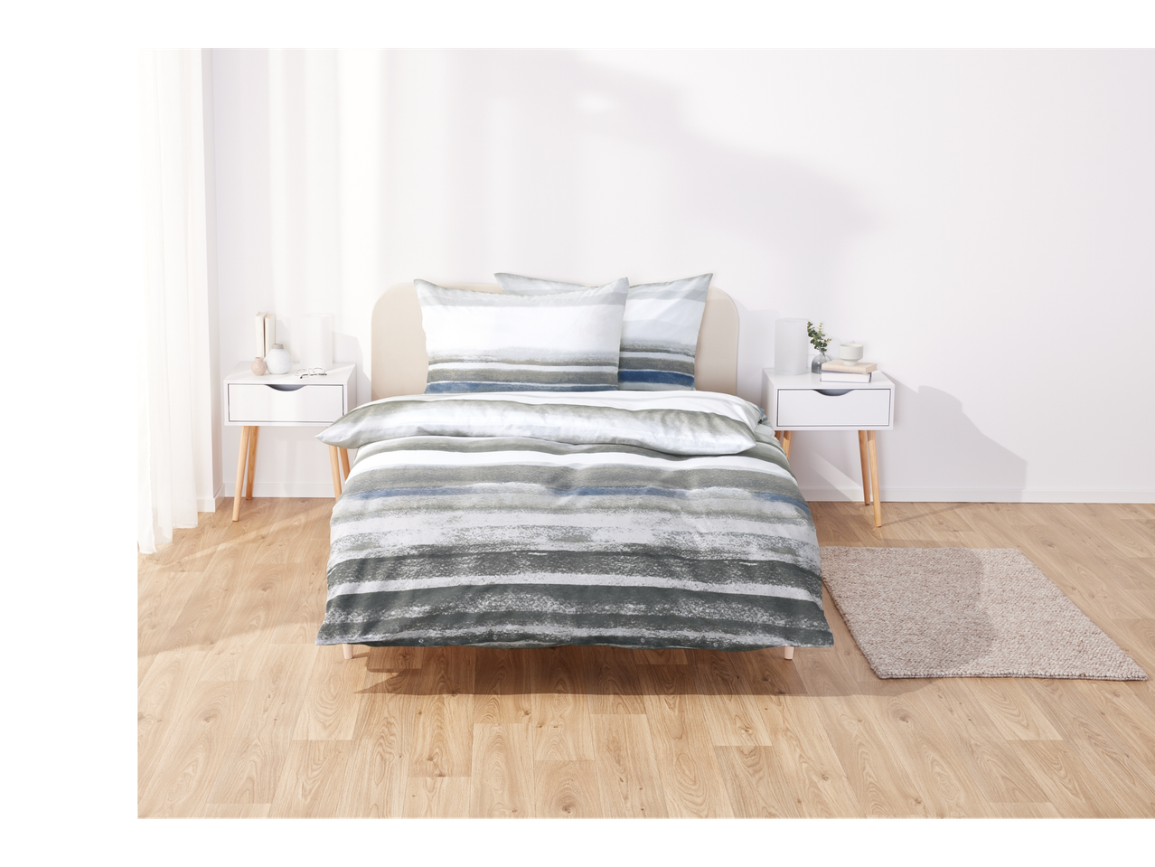 Grey and blue striped bedding on a bed.