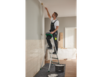 Painter painting a wall from a ladder, paint bucket.