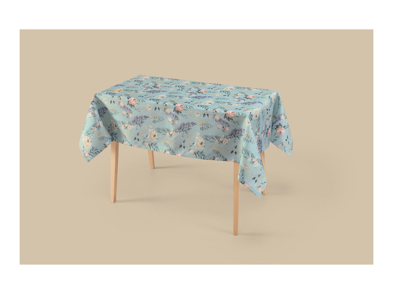 Light blue tablecloth with a floral pattern of pink and white roses and green leaves on a table.
