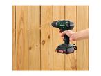A person drilling into a wooden fence with a cordless drill.