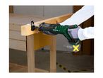 Person using a cordless reciprocating saw to cut a wooden beam on a workbench.