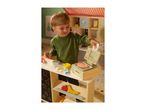 A child playing with a wooden toy market stall, featuring a scale, food items, and a chalkboard.
