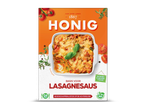 Verpakking voor lasagnesaus met een afbeelding van een ovenschotel met lasagne en tomaten.