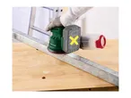 A cordless orbital sander with a dust collector being used on a metal bar.