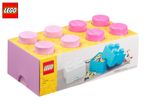 Pink and yellow storage brick packaging with a blue storage brick filled with toy bricks.