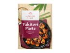 Japanese style yakitori paste packaging with chicken pieces, sesame seeds, and bamboo mat.