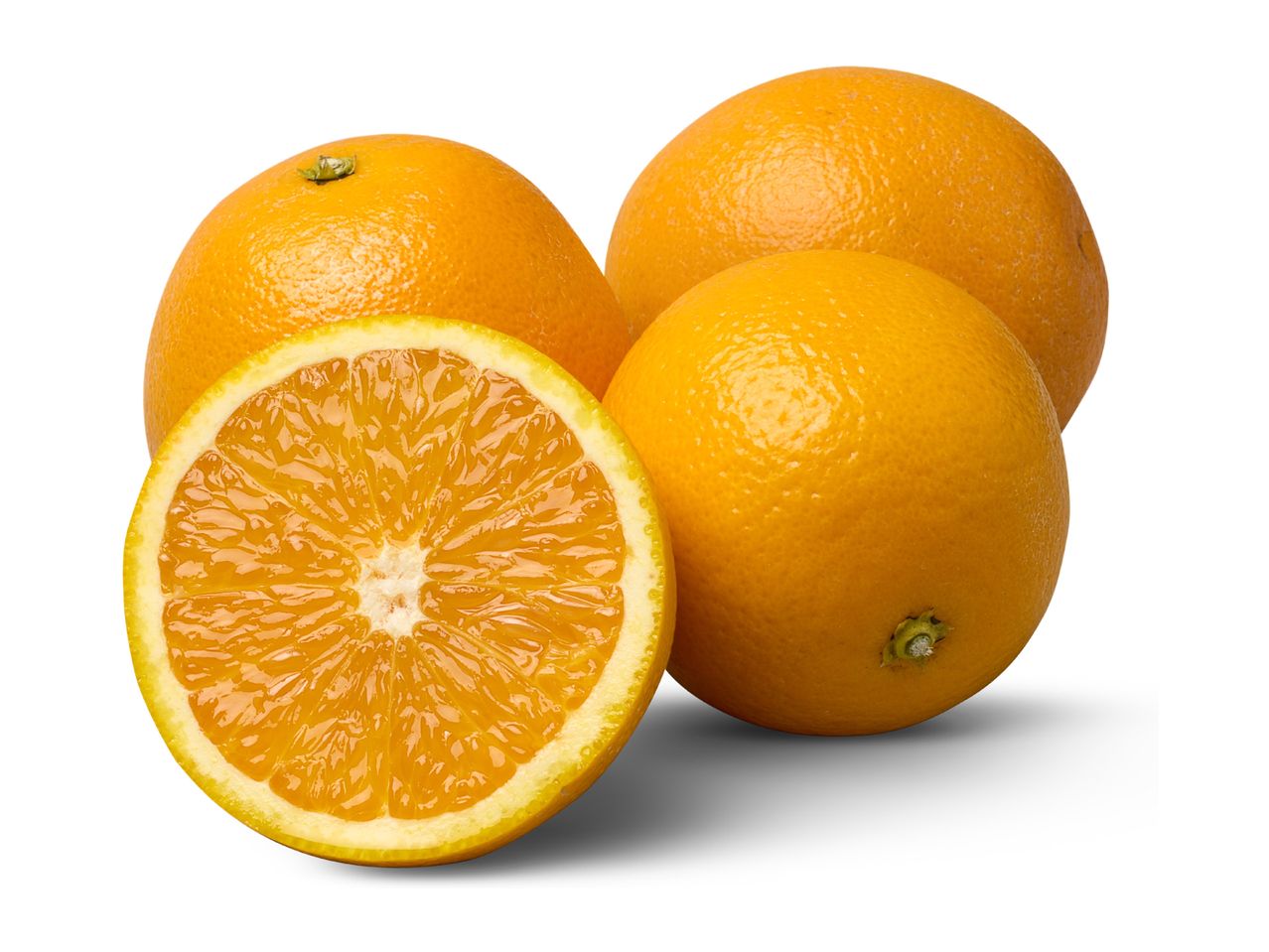 Three whole oranges and one orange half, showing the juicy segments.